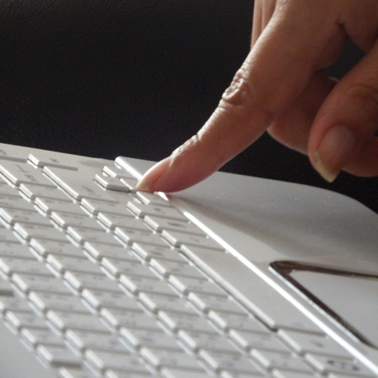 A finger touching a keyboard